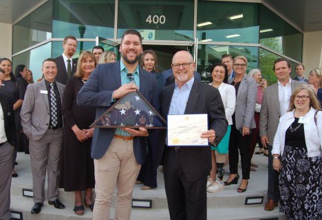 Highlighting the grand opening of the newly rebuilt Woodforest National Bank flagship location in historic downtown Conroe was the presentation of a commemorative United States flag by Craig Lewellyn (left) of Congressman Kevin Brady’s office to Jay Dreibelbis (right), President and CEO of Woodforest National Bank.