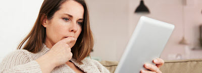 Woman looking at her tablet.